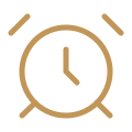 An alarm clock with a beige color and two bells on top.