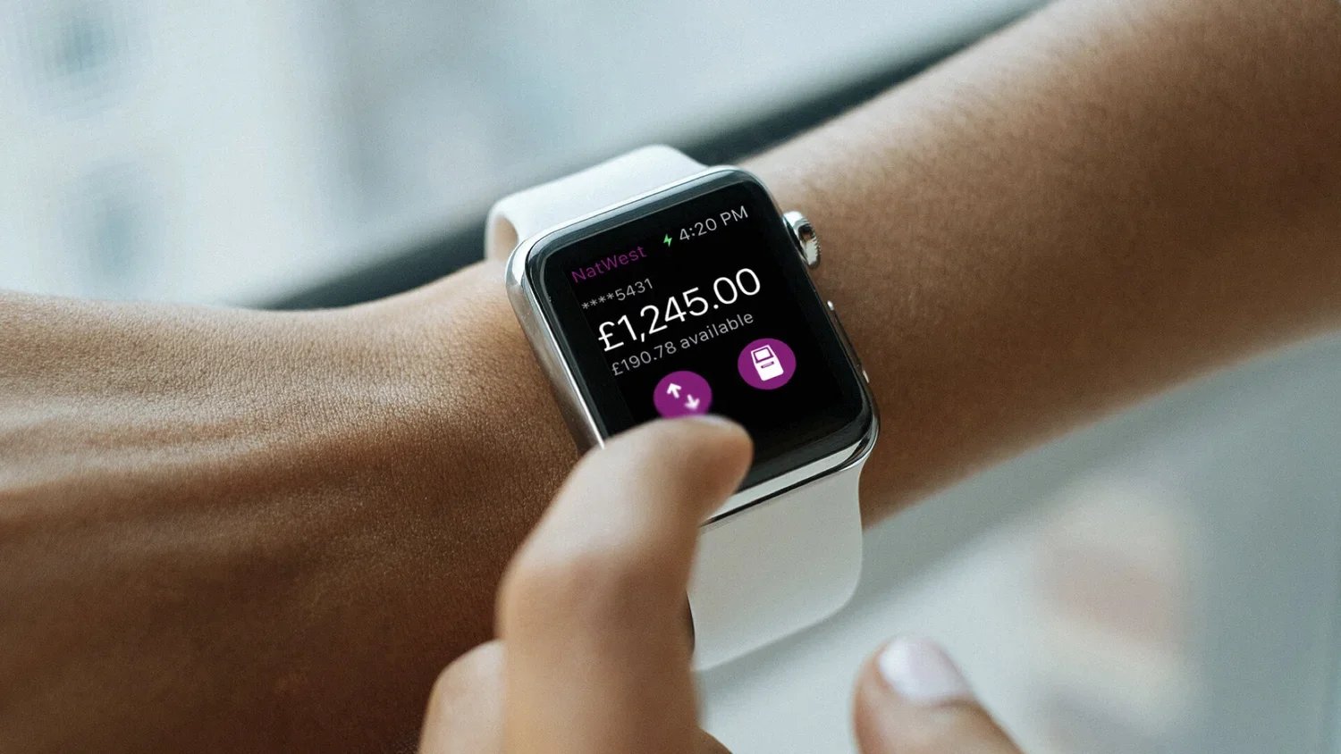 Close-up of a person's wrist wearing an Apple Watch displaying the NatWest banking app featuring Get Cash