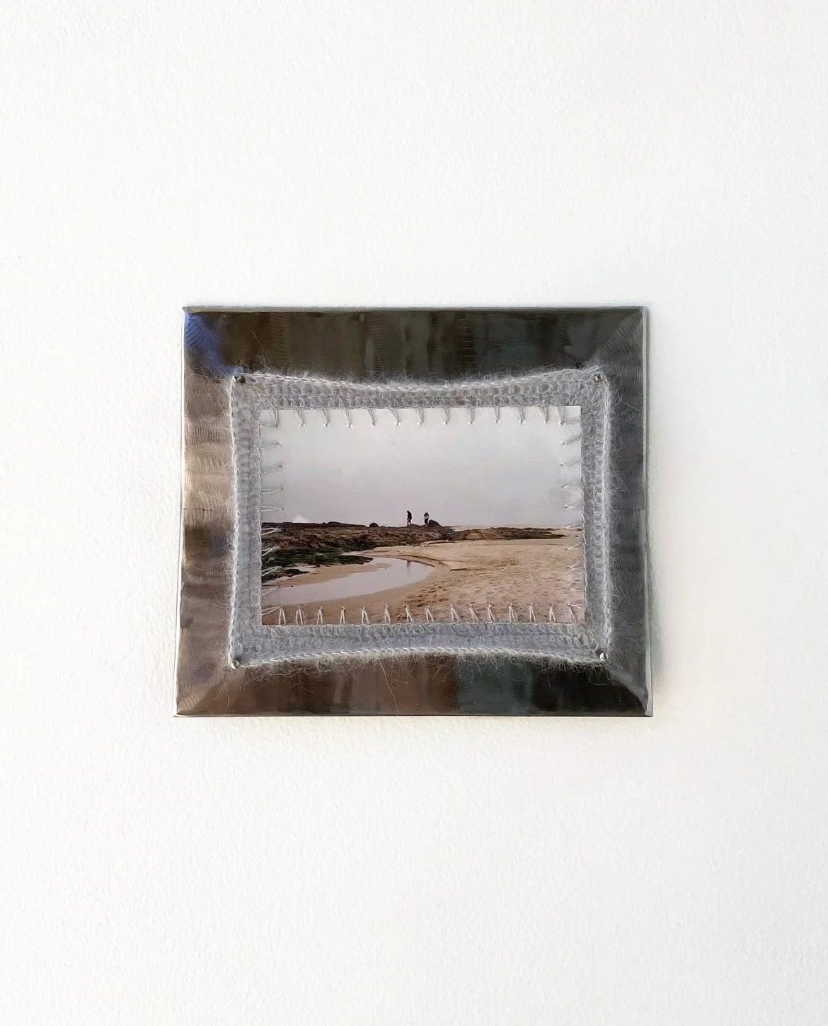 Salt Spray, 2024. Welded steel, print on photo paper, mohair yarn crocheted border.