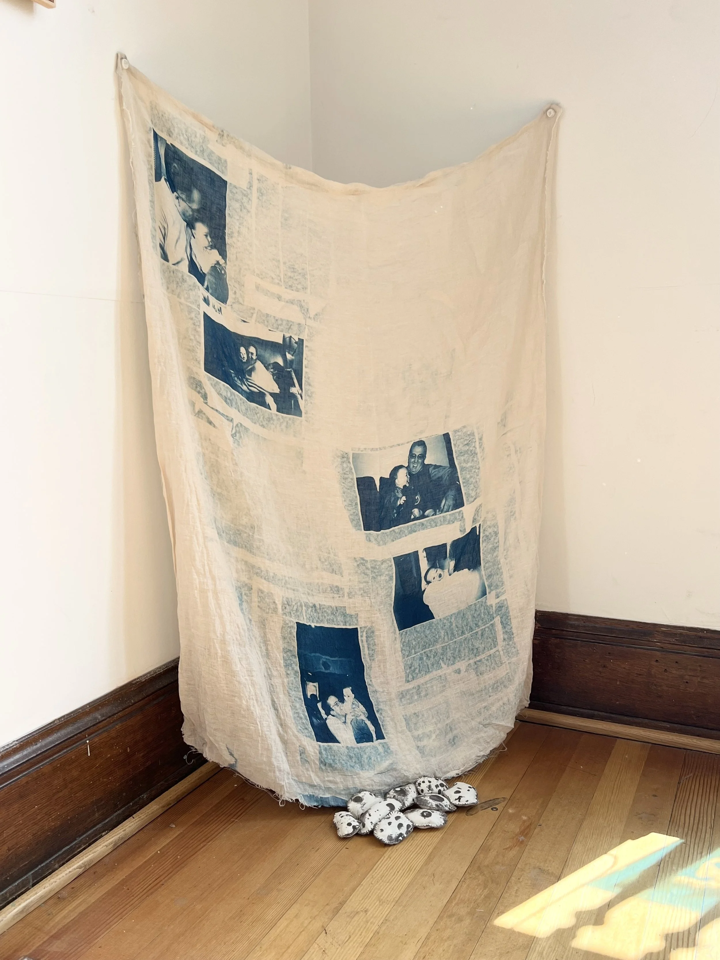 Untitled, 2026. Cyanotype family images on loose-weave linen, Van Dyke printed hag stones on cotton muslin, sashiko thread embroidered edging, vintage canvas backing. 