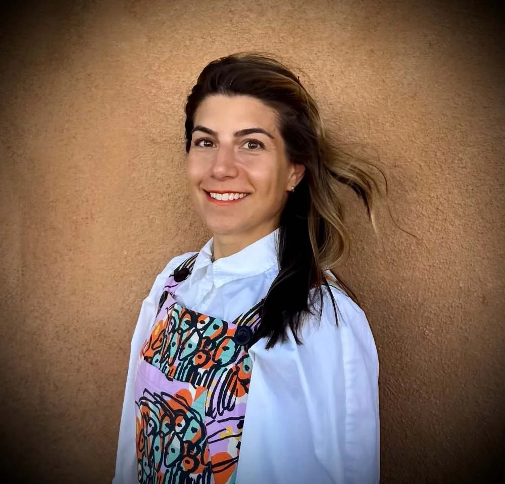 A woman with shoulder-length hair smiling and looking at the camera.