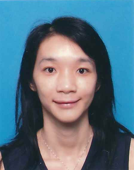 Portrait of a woman with black hair smiling, wearing a dark top and a necklace, against a blue background.