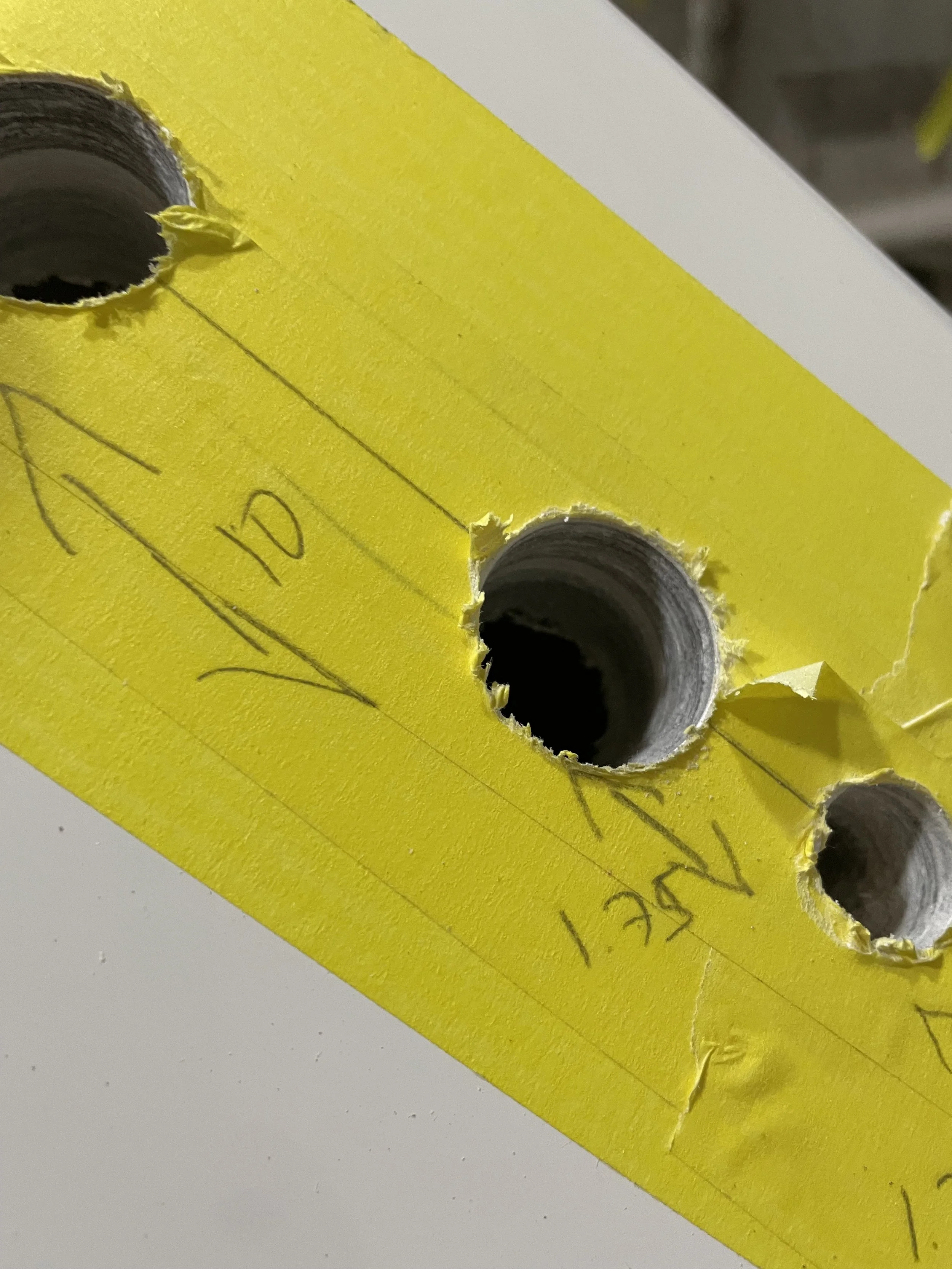 Material Thickness: Openings cut for hardware installation reveal the laminate thickness, bonded layers, and construction details inside the hull and deck components.