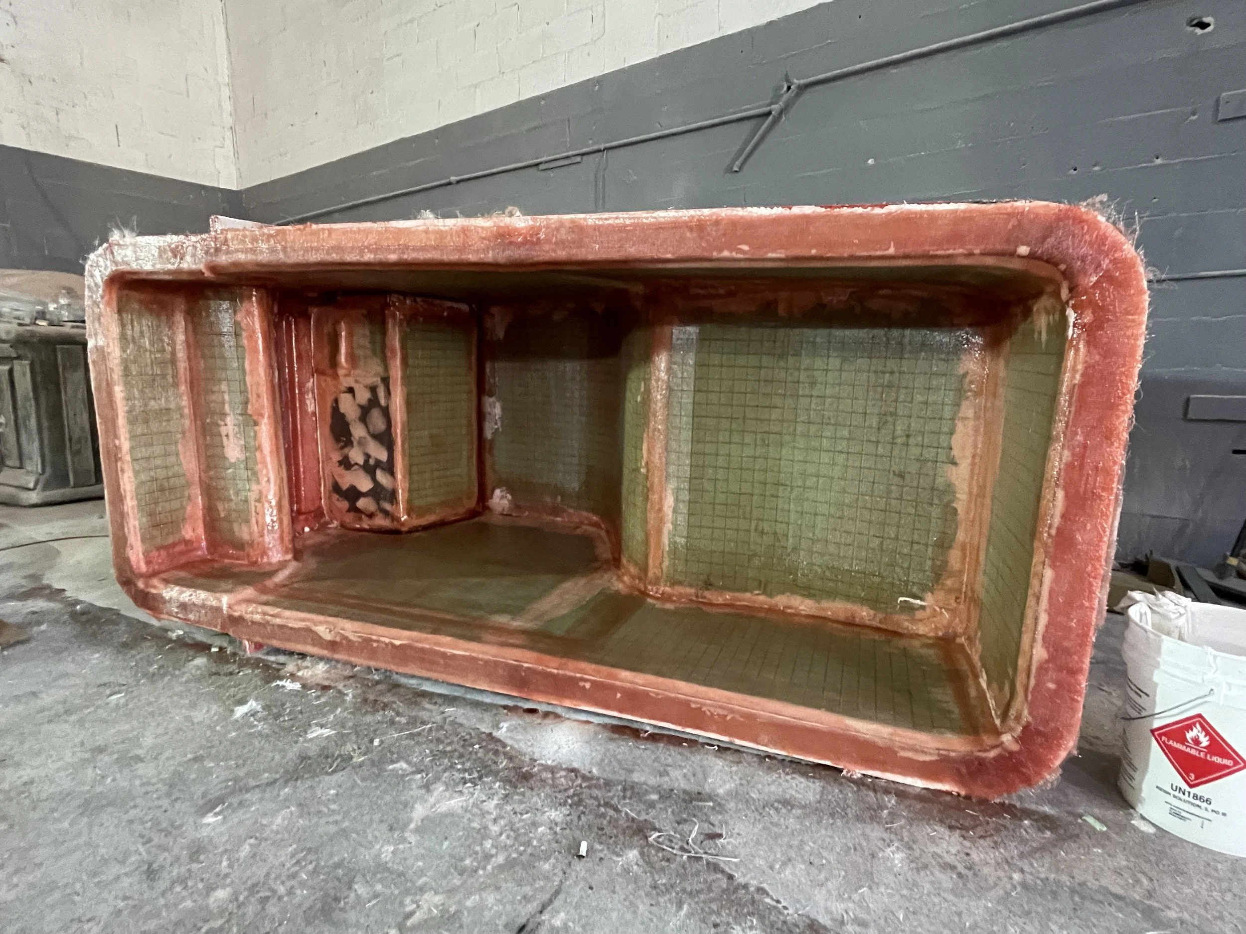 Console Construction: Fully laminated console, still in the mold before painting, showing foam core, 4001 bonding compound, and Kevlar reinforcement in the control mounting areas.