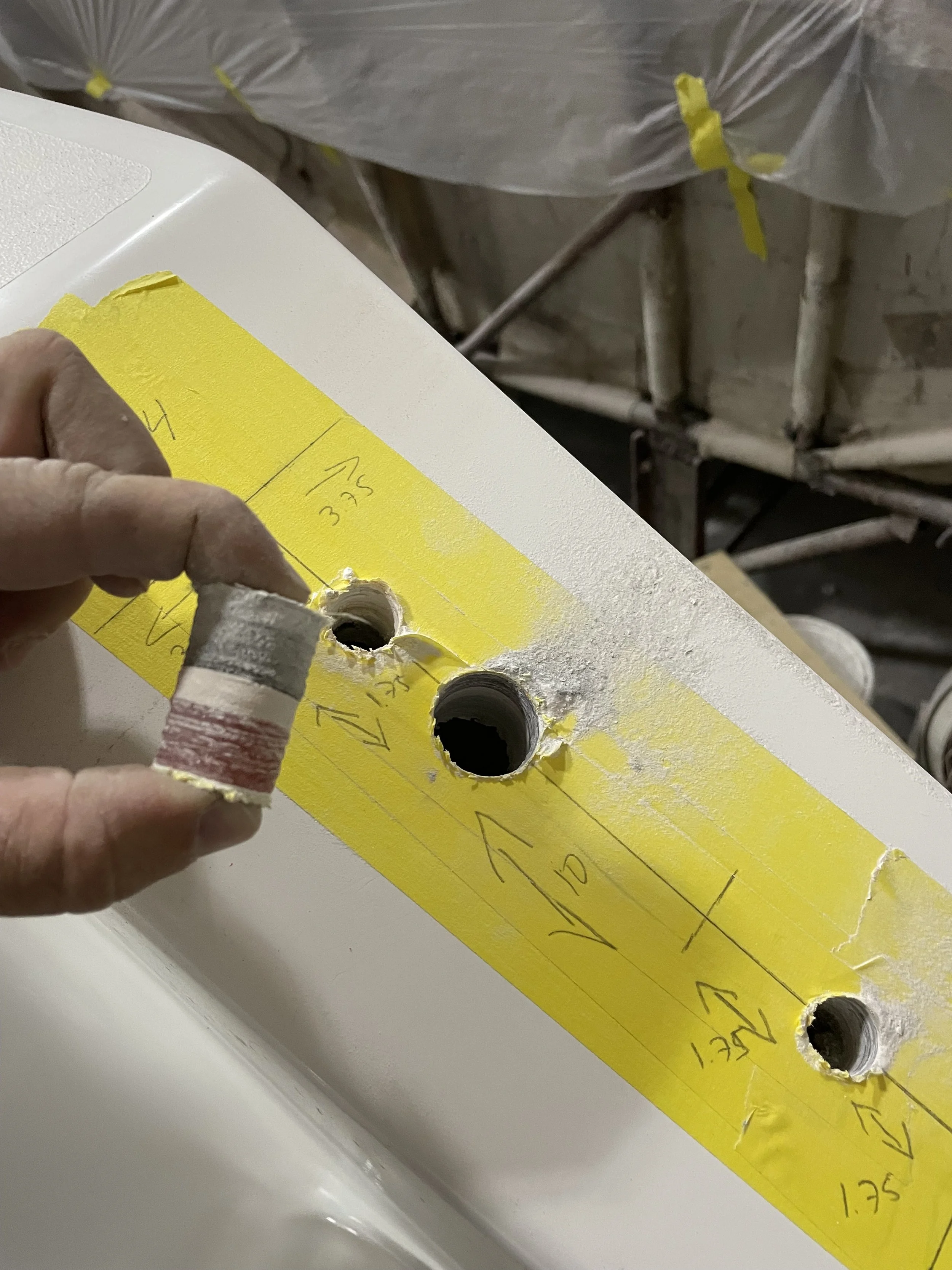 Material Thickness: Openings cut for hardware installation reveal the laminate thickness, bonded layers, and construction details inside the hull and deck components.