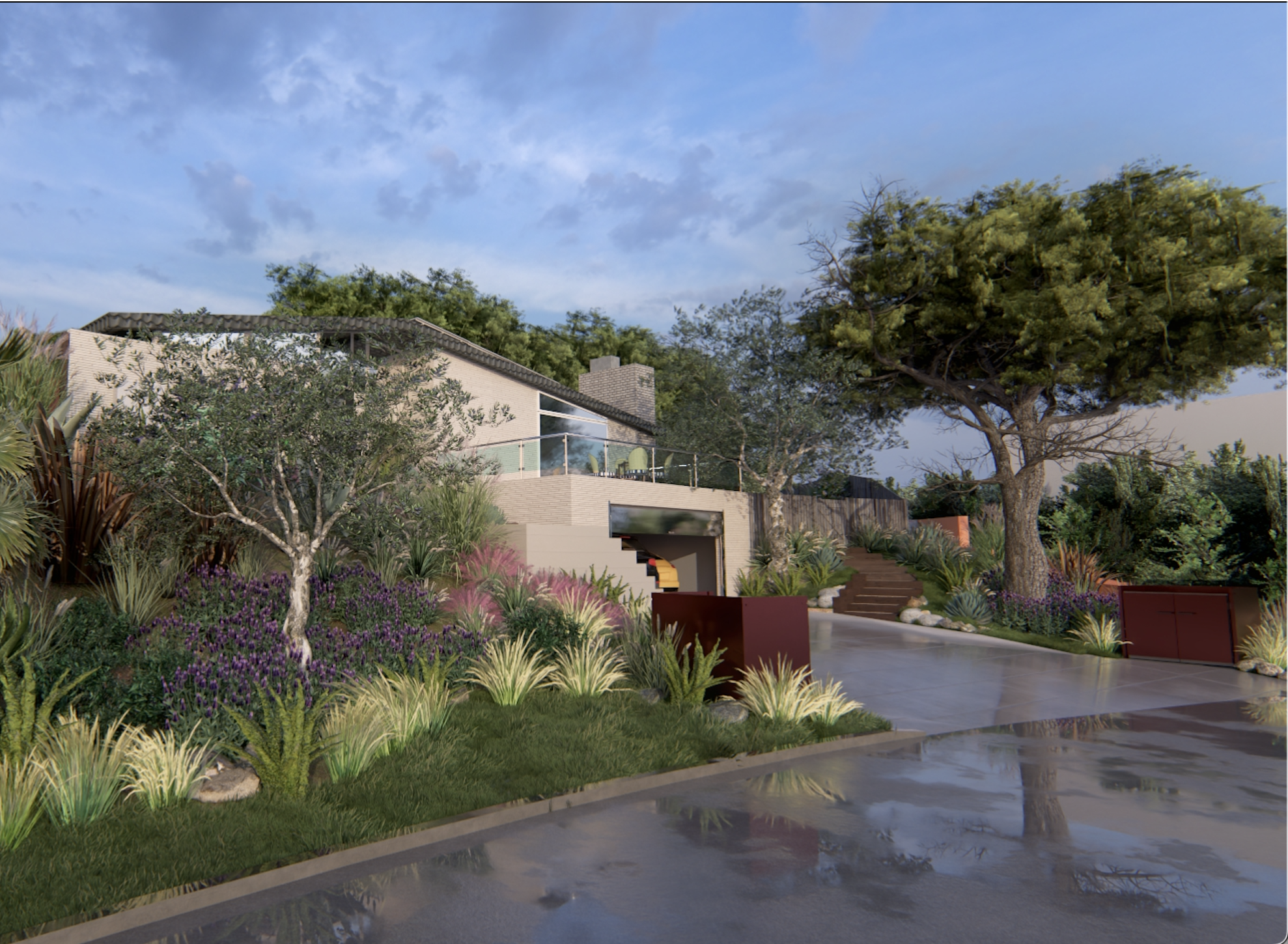 A modern house with a beige brick exterior, large glass windows, and a sloped tiled roof. The house has a balcony with glass railing, surrounded by lush landscaping including various trees and flowering plants. There is a pathway with stone steps leading up to the house, and a wet concrete patio reflects the sky and trees.