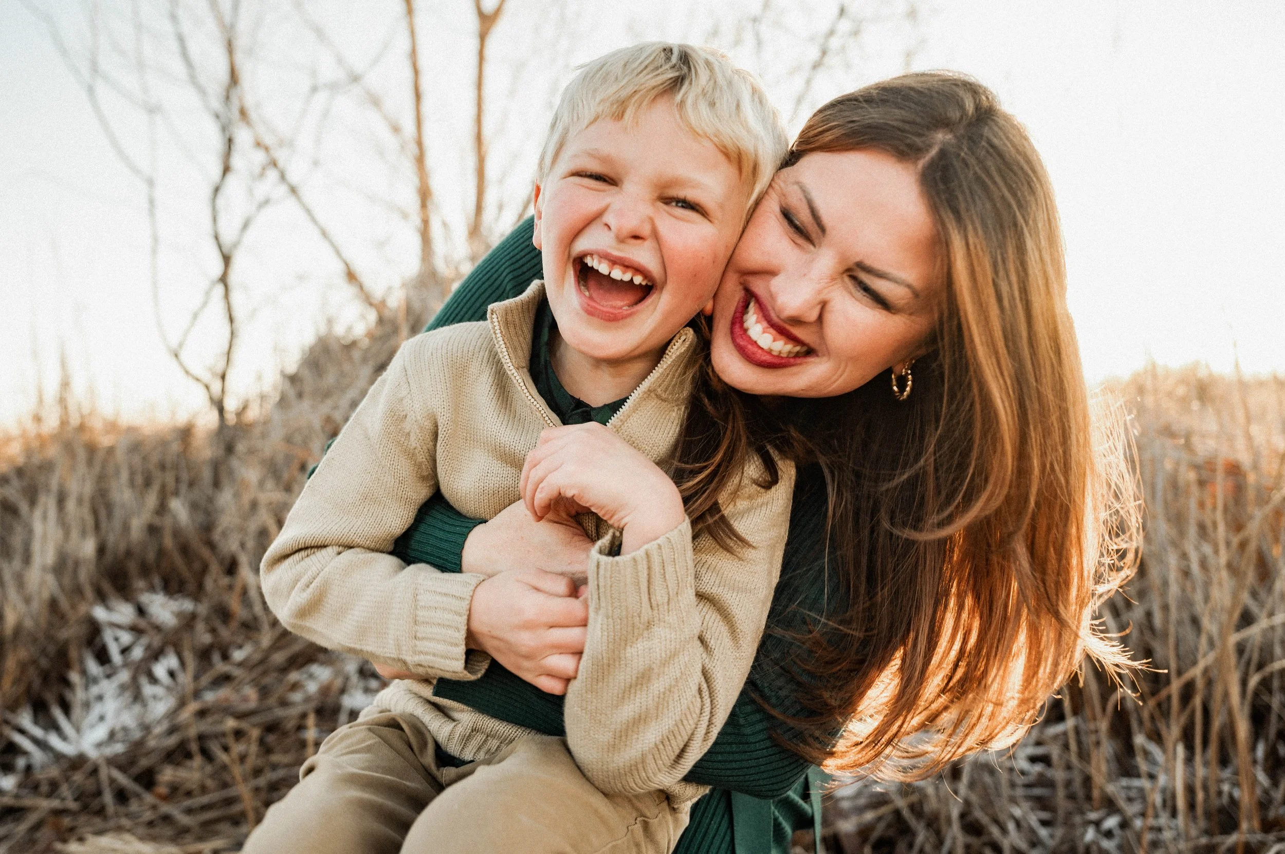 Lara laughing and hugging her son