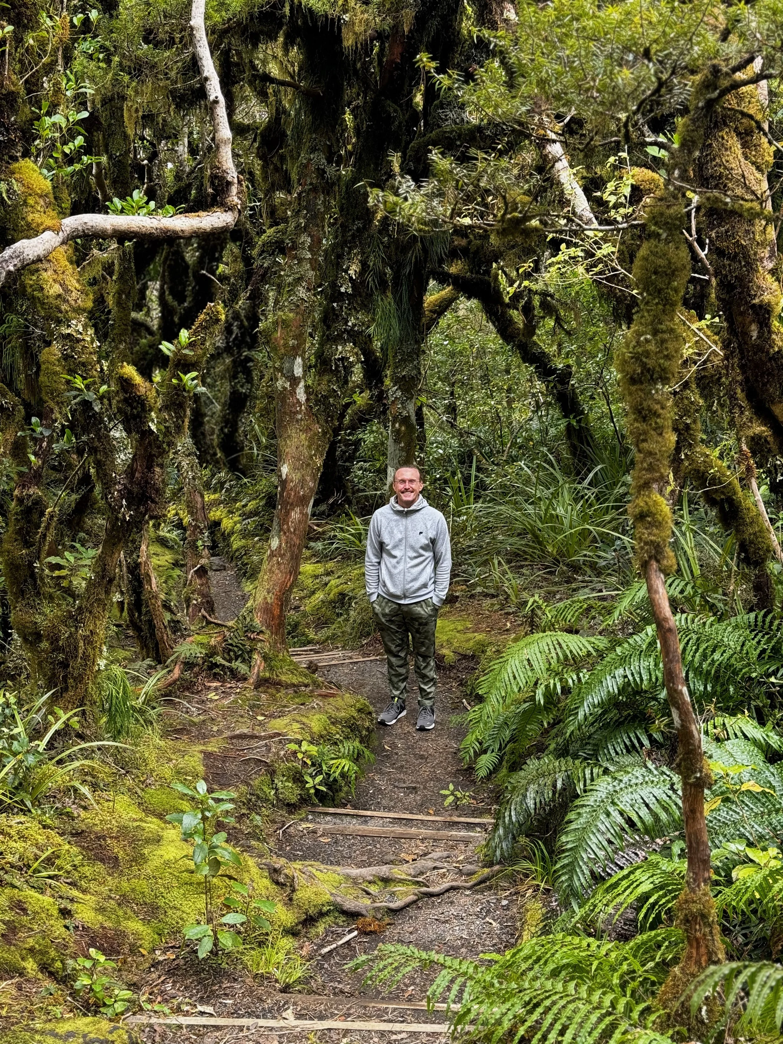 Joshua Beeson on a mossy rainforest trail in New Zealand