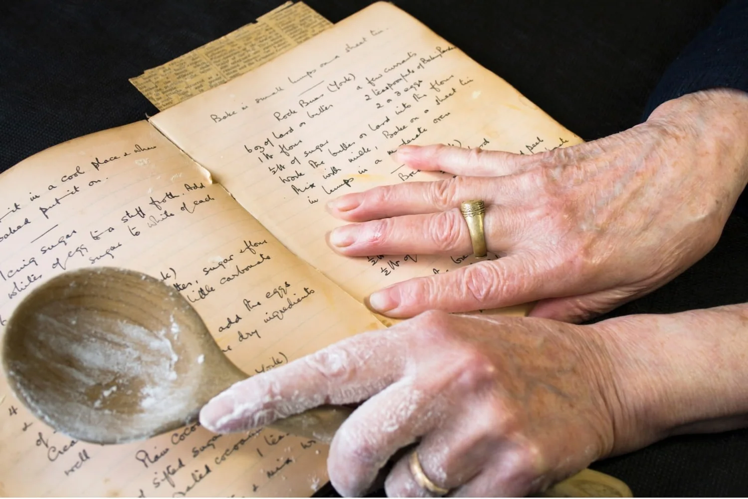 An old handwritten recipe book, its pages worn with use.