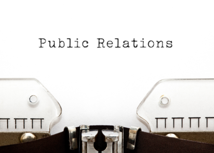 Close-up of a typewriter with the words 'Public Relations' typed on paper.