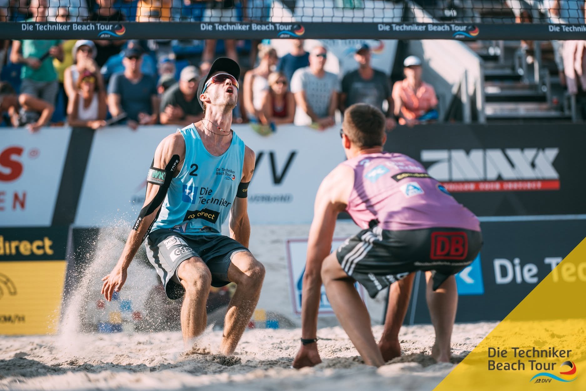 Beach volleyball players competing on a sandy court during the Die Techniker Beach Tour.