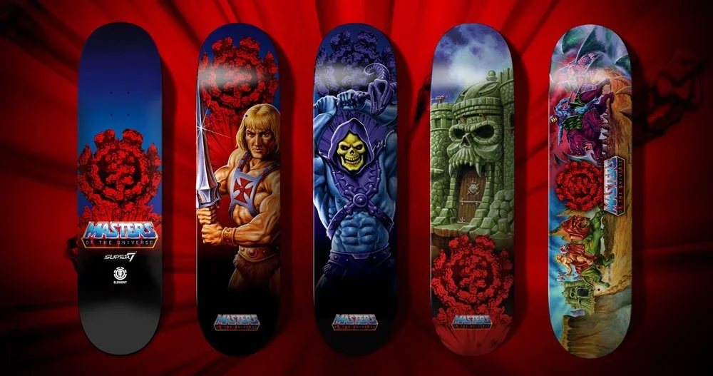 Set of five skateboard decks with Masters of the Universe themed artwork, each featuring different characters and scenes from the series, with a red background.