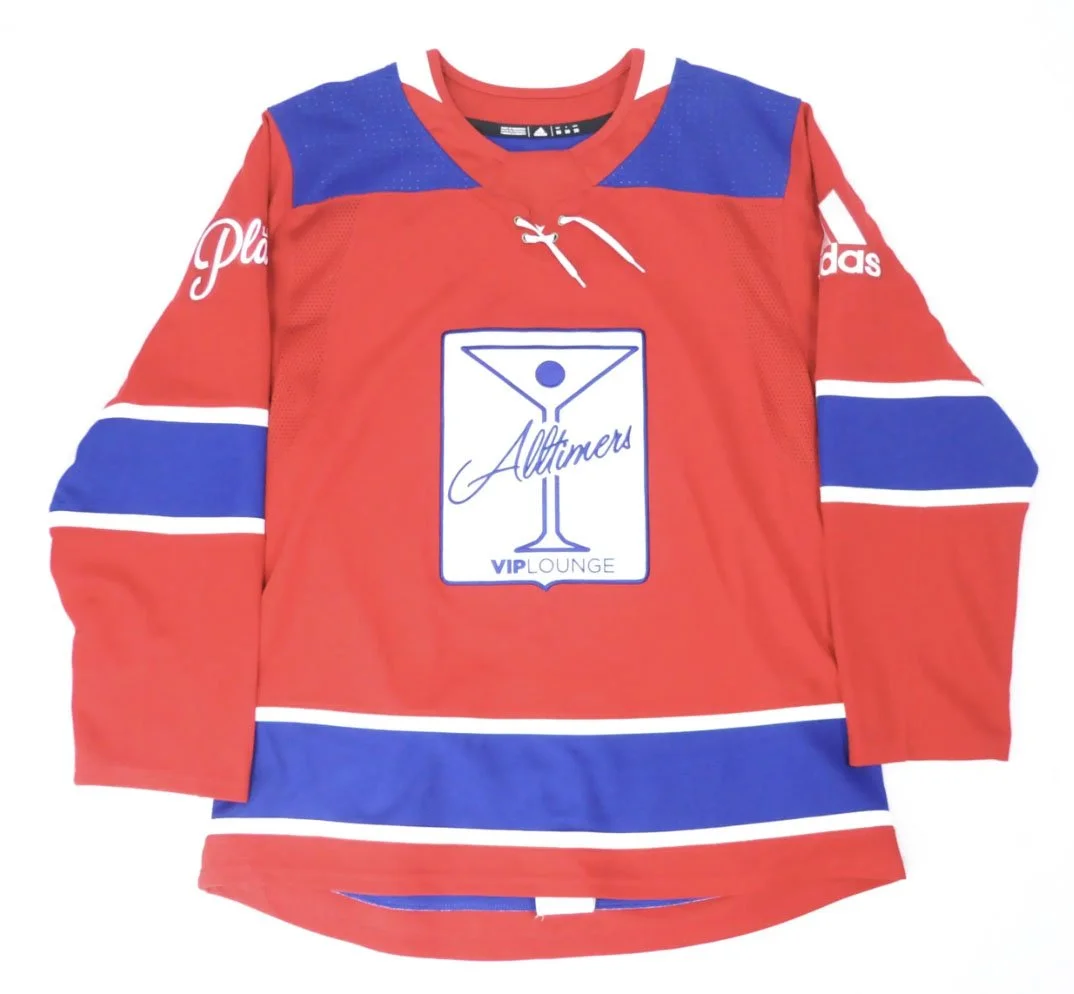 Red and blue sports jersey with sponsor logos, long sleeves, and a graphic of a cocktail glass with the words "Alltimers VIP Lounge" on the front.