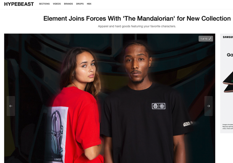 Two models wearing Star Wars-themed apparel; the woman has a red shirt with a Mandalorian design on the back, and the man wears a black shirt with Star Wars-themed patches.