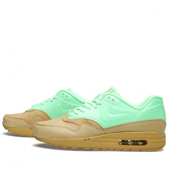 Pair of Nike sneakers with neon green upper and tan sole, placed on a white background.