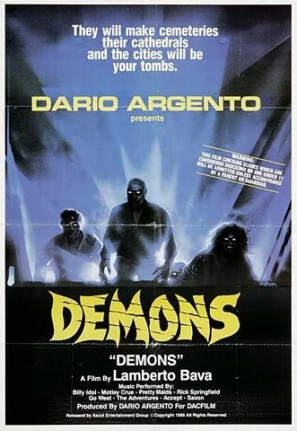 Movie poster for 'Demons' directed by Dario Argento, featuring three shadowy figures; lightning in the background, with tagline about cemeteries, cathedrals, and tombs, and titles in bold yellow and white text.