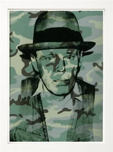 A portrait of a man wearing a fedora hat, with a camouflage pattern overlay.