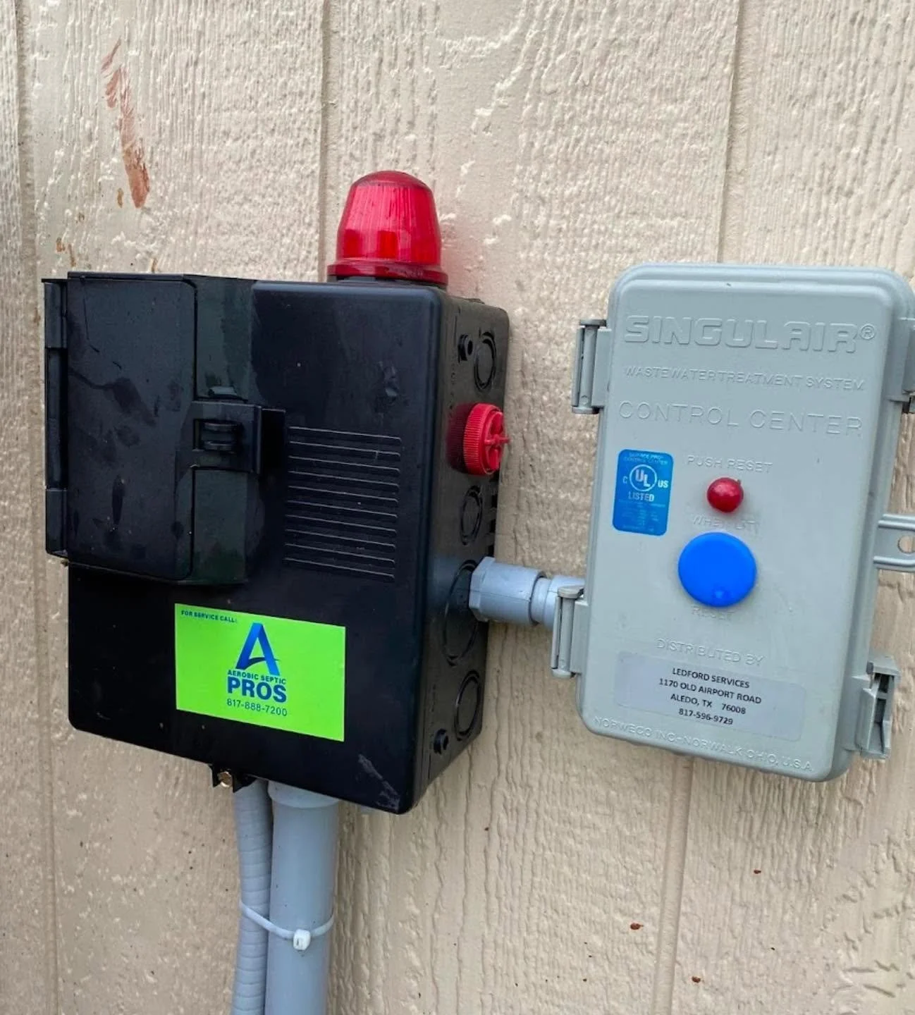Septic control system and electrical box mounted on a wall.