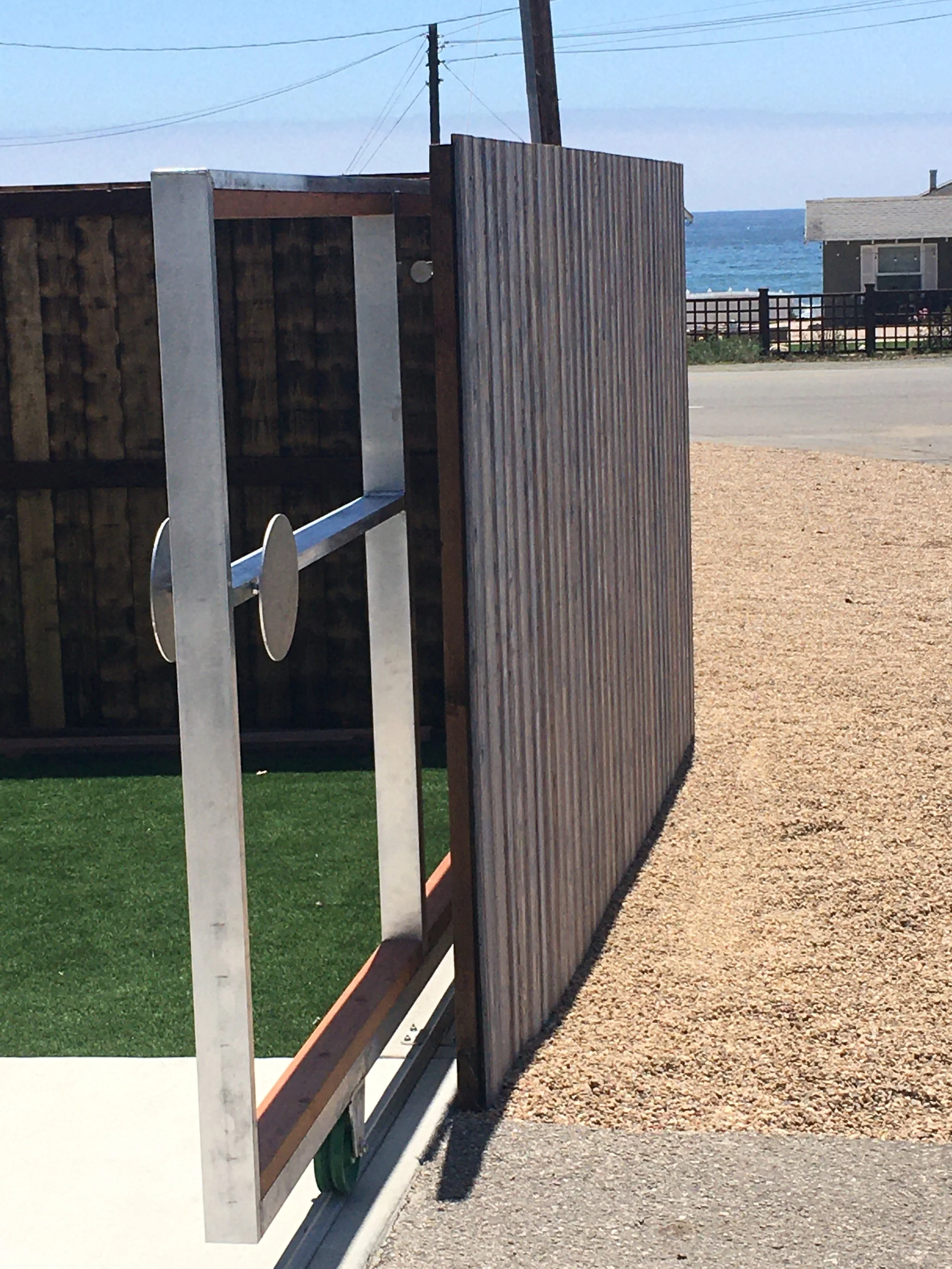 CAYUCOS METALWORKS PROJECT OF A CUSTOM SHOU SUGI BAN SLIDING ALUMINNUM GATE IN CAYUCOS