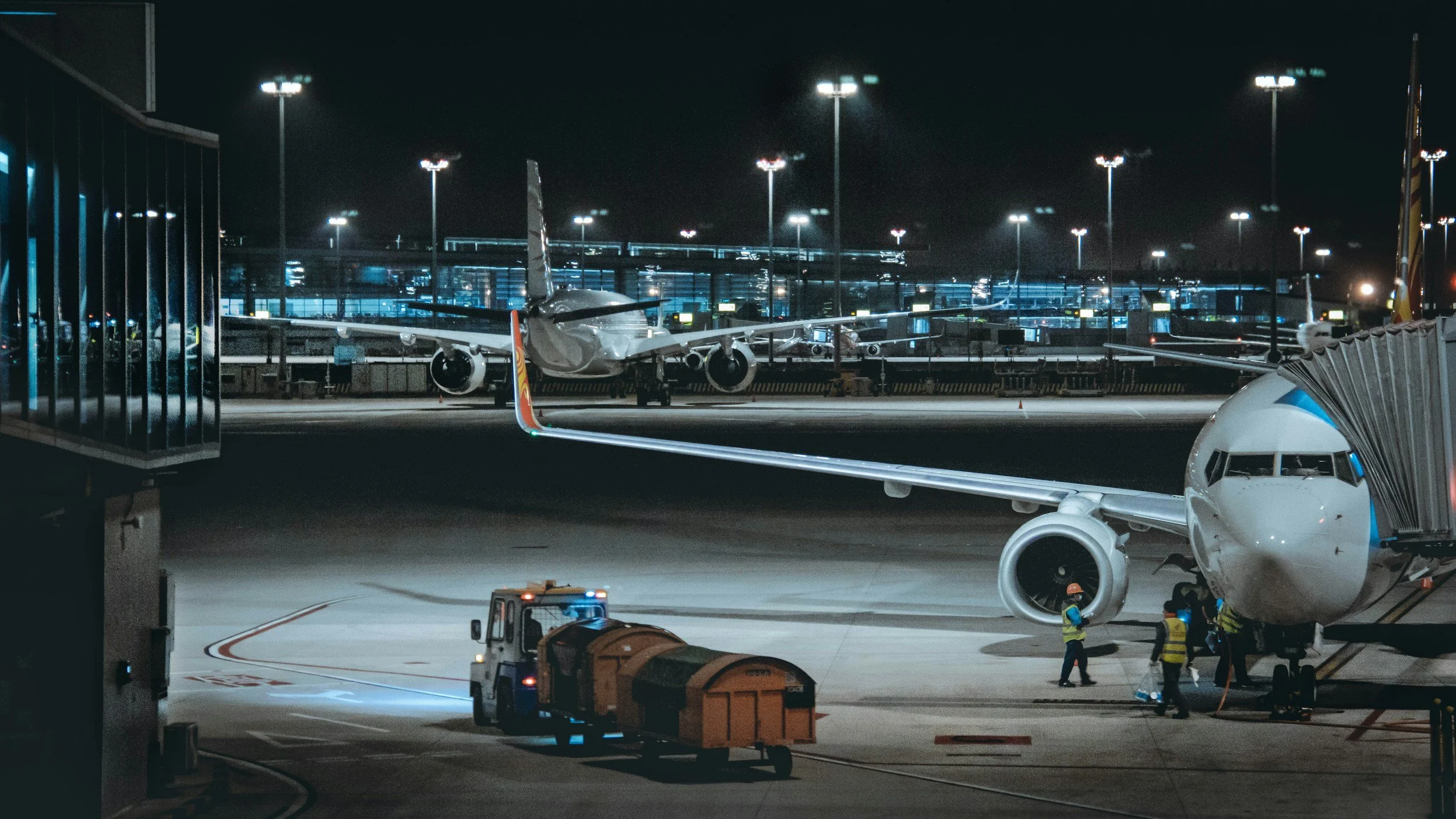 Aircraft being serviced on an airport ramp at night