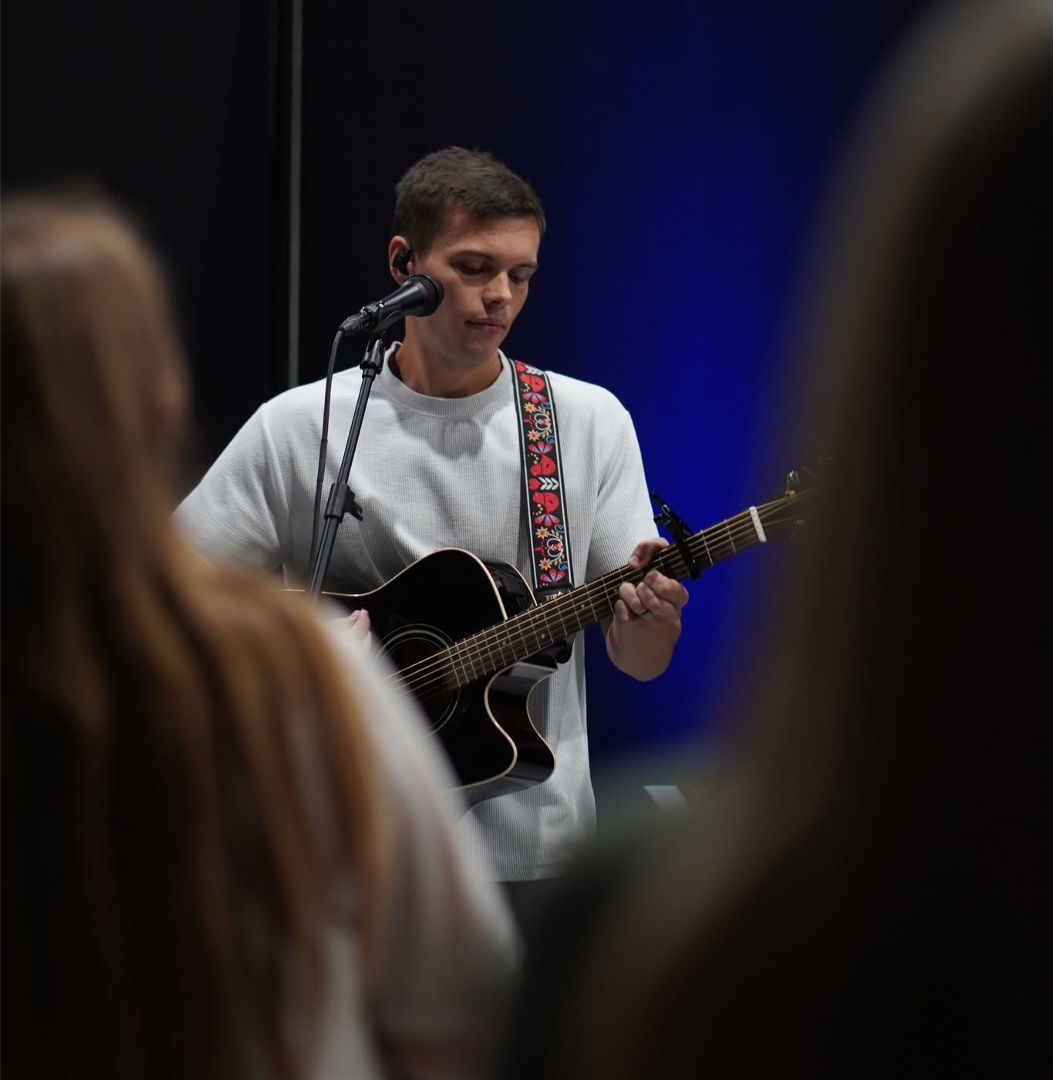 Worship leader playing acoustic guitar during a 417 Church worship service in Willard, Missouri.