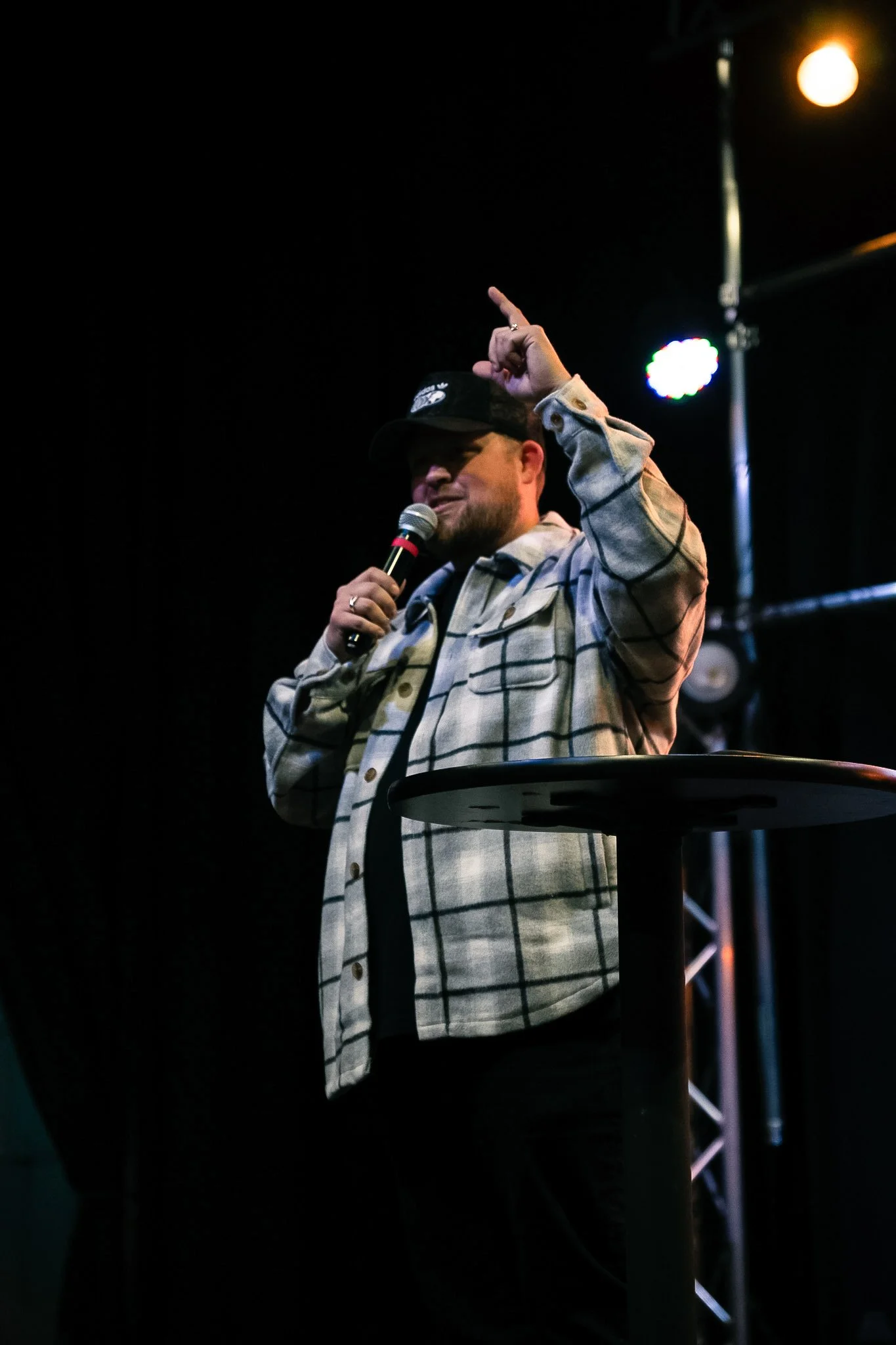 Pastor preaching with a microphone during a 417 Church service.