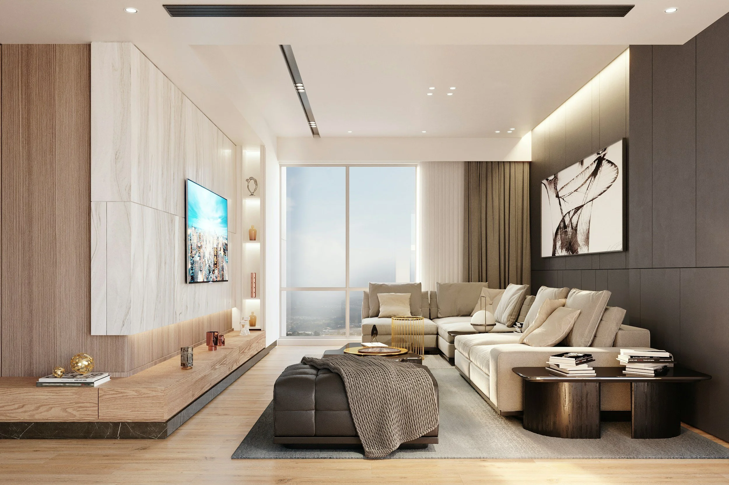 Modern living room with a large beige sectional sofa, black and gold coffee table, wall-mounted television, artwork, and decorative items, with large windows showing a city view.