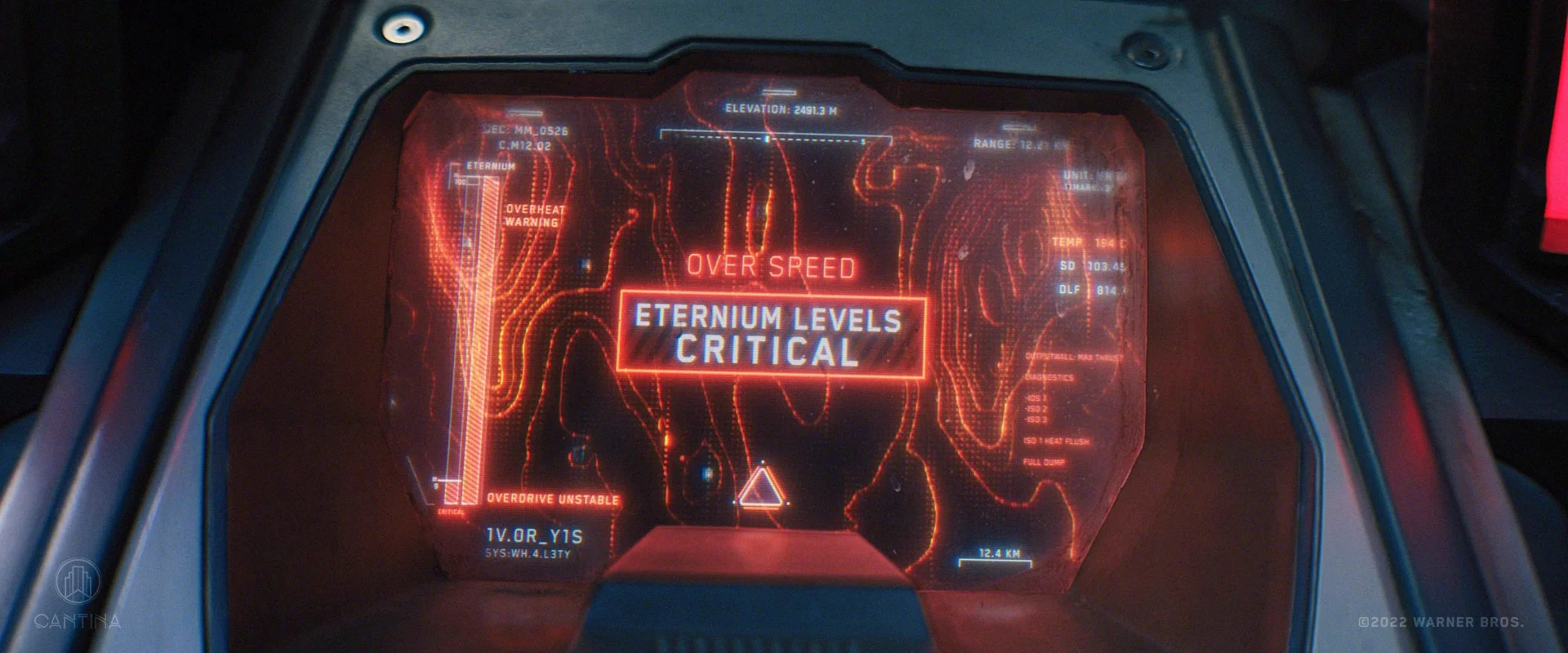 Futuristic spaceship cockpit with a warning on screen indicating "Over Speed," "Eternium Levels Critical," and "Overdrive Unstable." From DC's Black Adam film