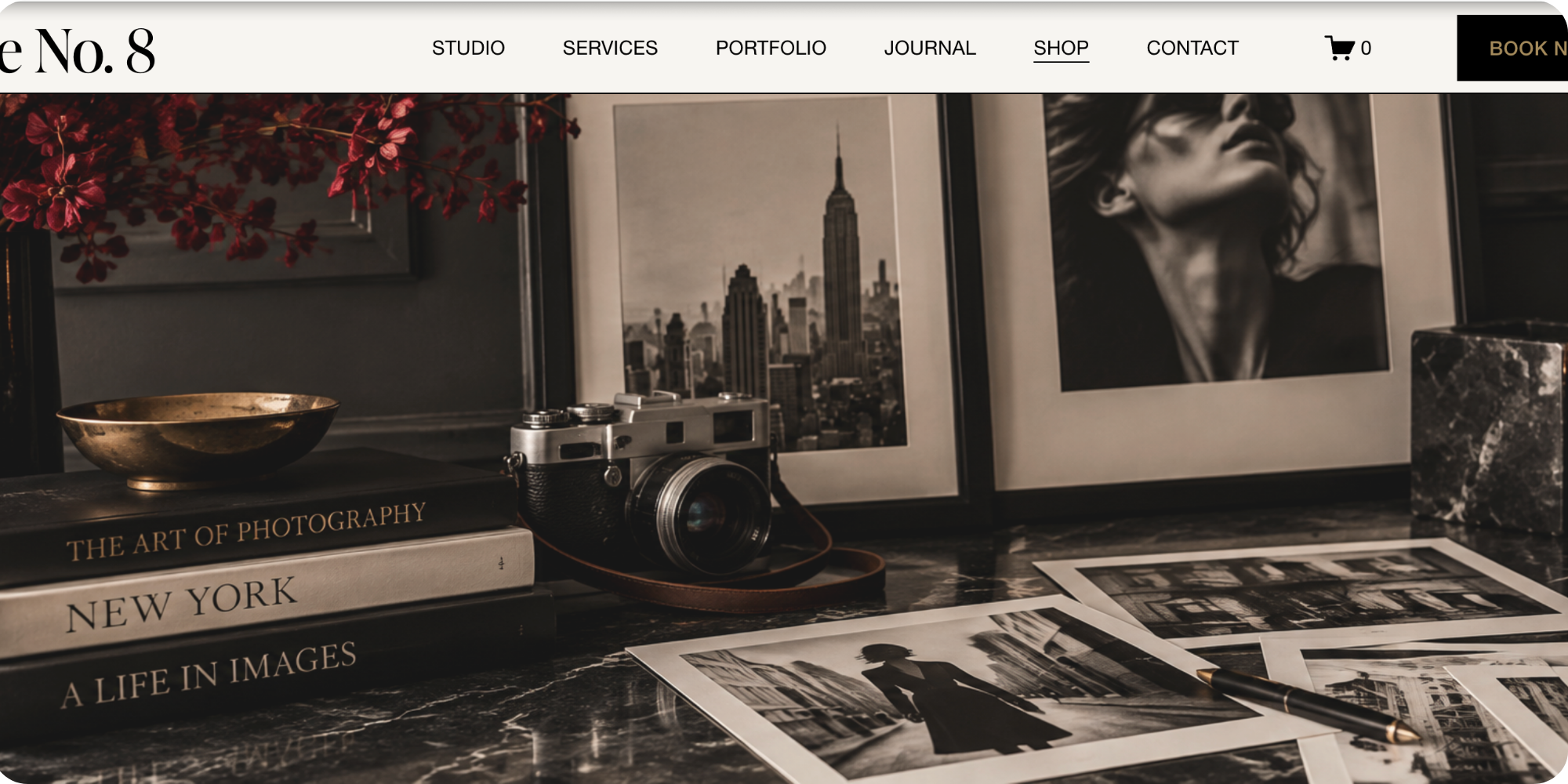 Camera and prints on marble table
