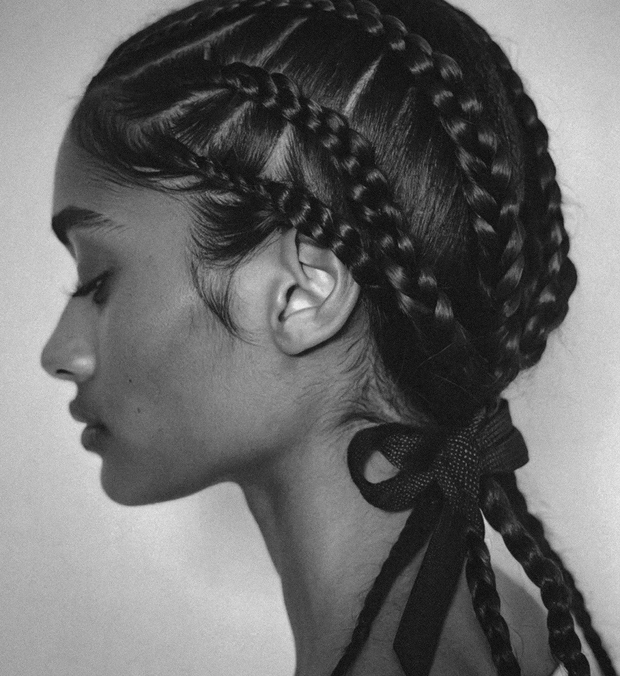 Black and white photo of women with dark hair and braids