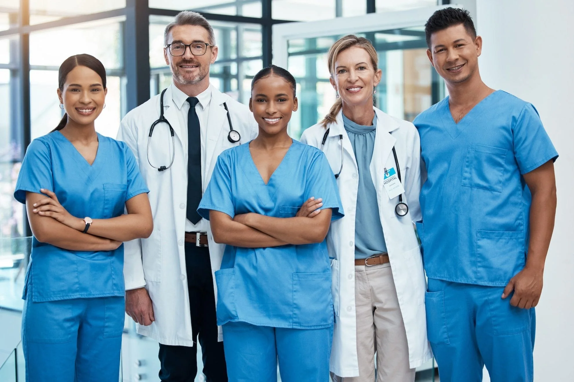 A healthcare team of doctors and nurses together in a bright hospital