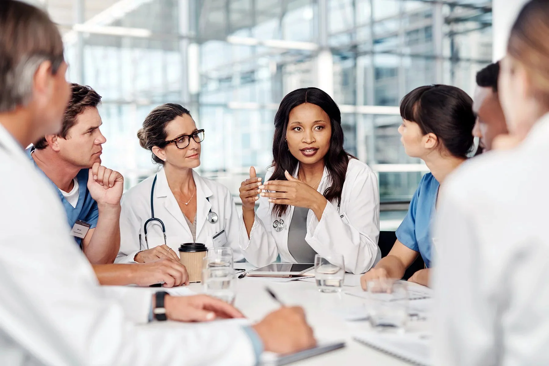 Clinicians and care team members collaborating around a table