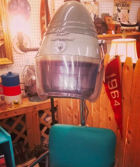 Vintage helmet-style hair dryer on a salon chair in a retro barber shop or salon