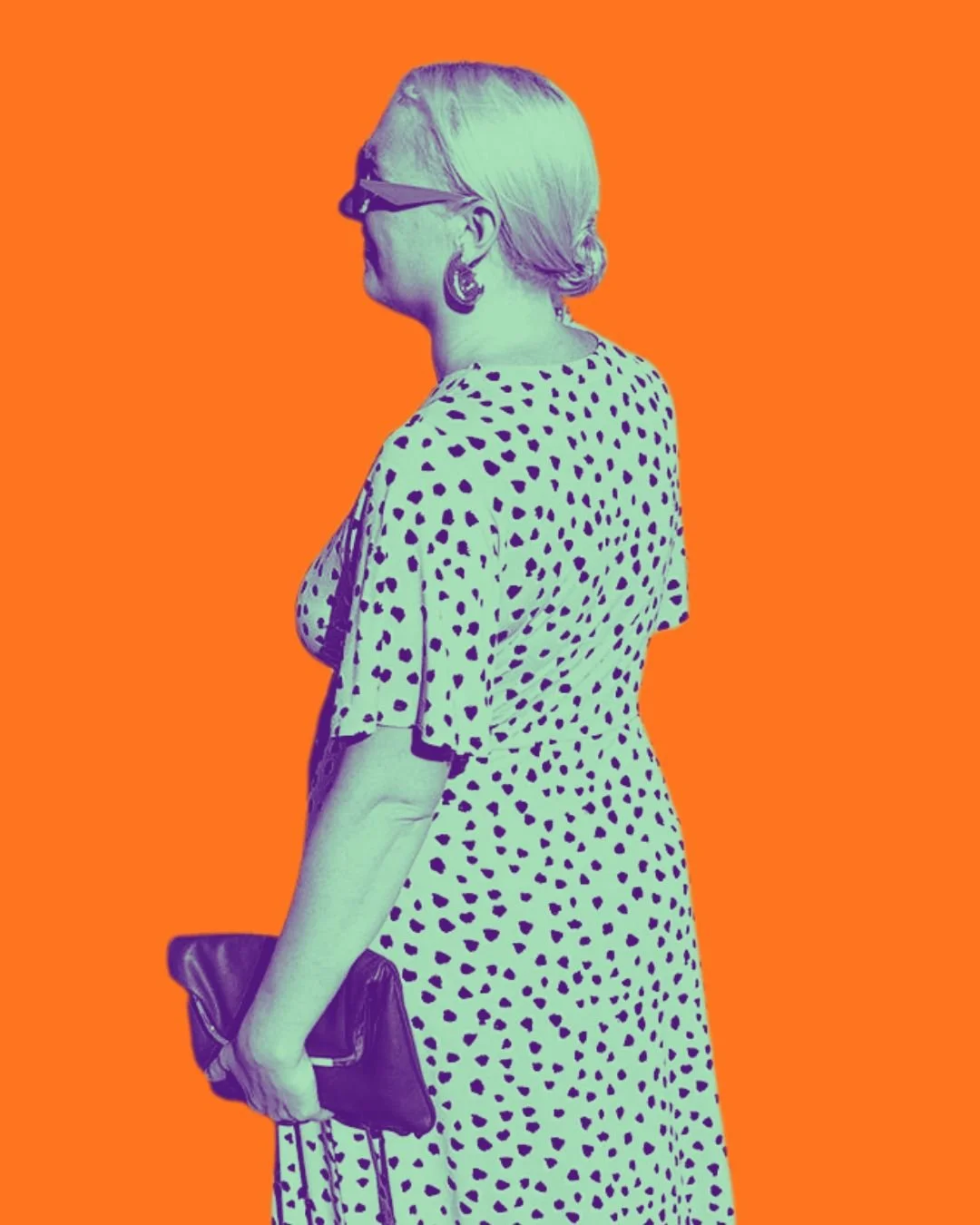 A woman with blonde hair in a bun, wearing sunglasses, earrings, a polka dot dress, holding a clutch, standing against an orange background.