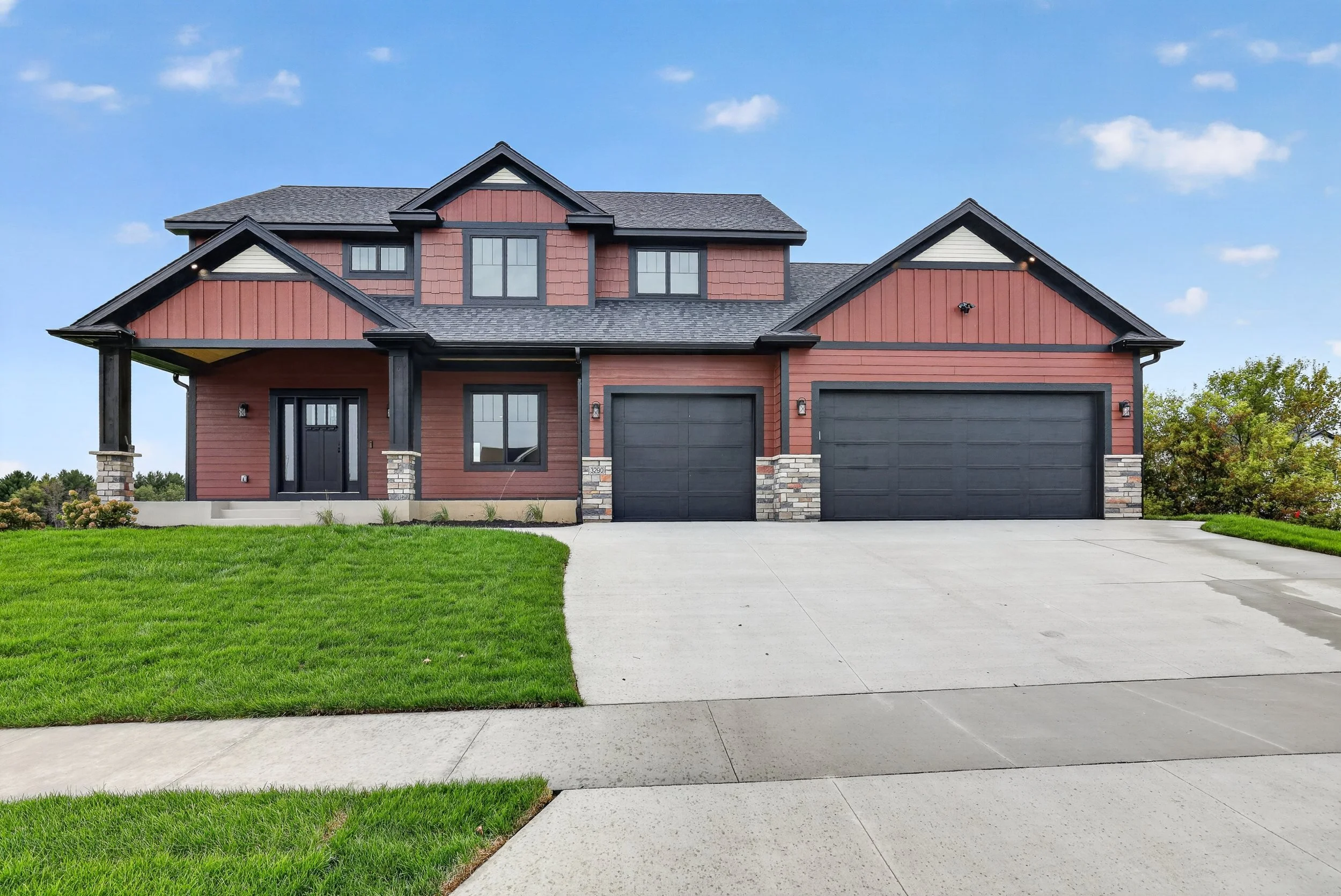 Two-story craftsman home with red siding photographed by All in One Media in Rochester MN