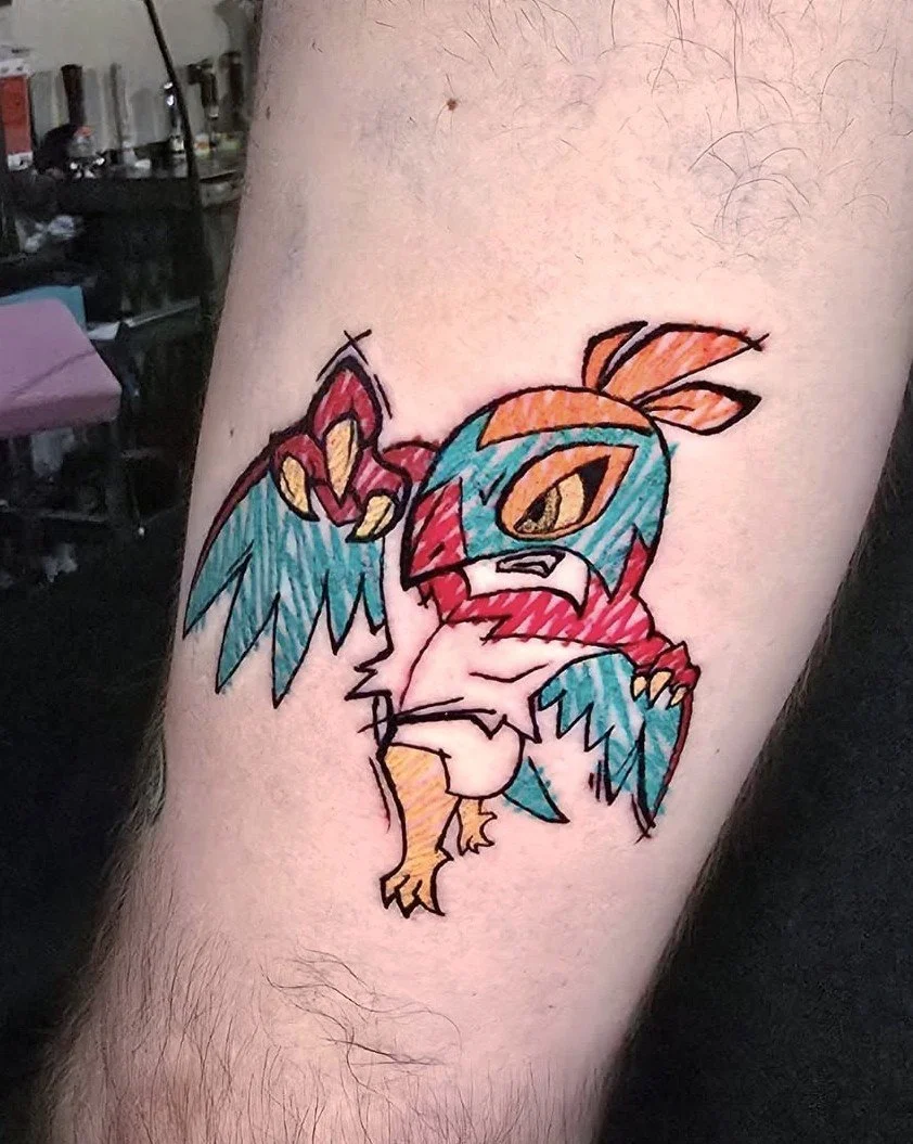 Tattoo of a colorful, cartoonish bird with exaggerated features, perched on a person's arm.