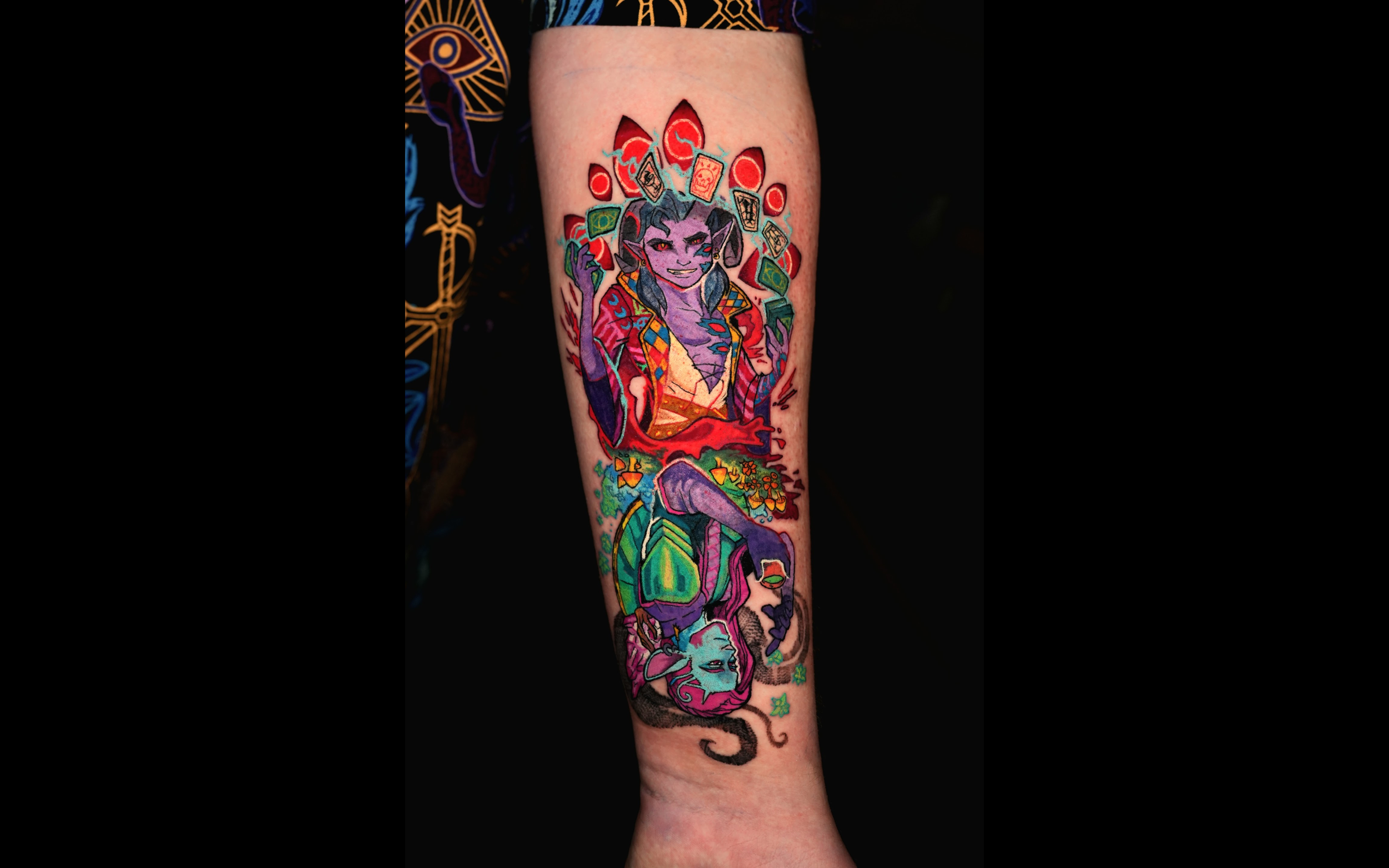 Colorful tattoo on a person's leg featuring a cartoon-style female character with purple skin, black hair, and pointed ears, surrounded by playing cards, flames, and abstract patterns.