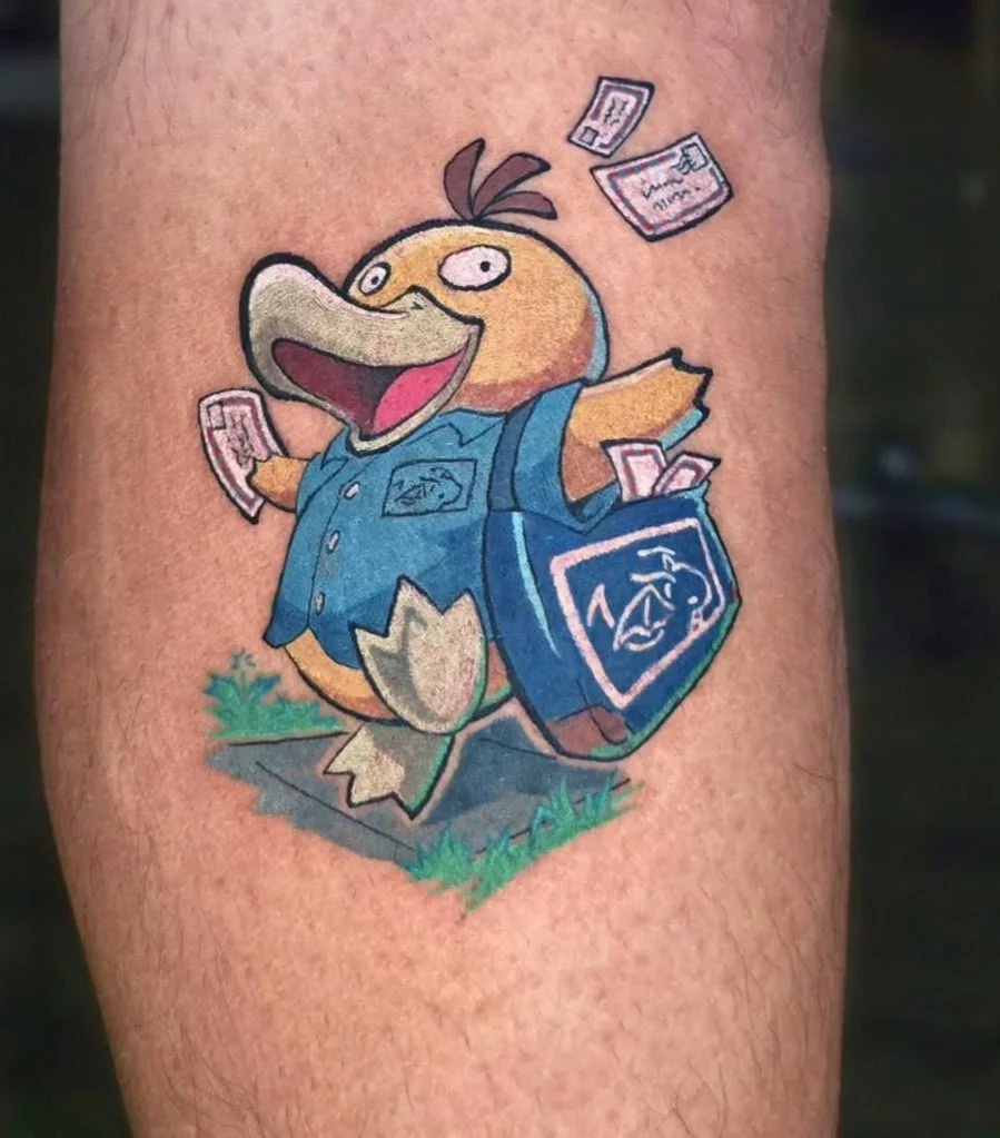 Tattoo of a cartoon duck dressed in a blue uniform, carrying a blue lunchbox with a duck logo, and holding cash, with money floating in the air.