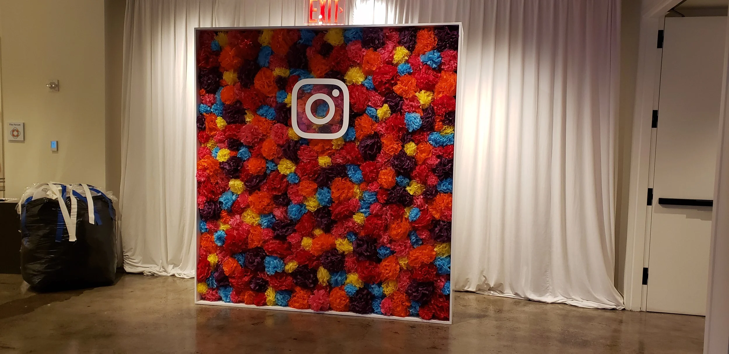 Instagram photo backdrop designed for an Instagram event using giant pom pom balls.