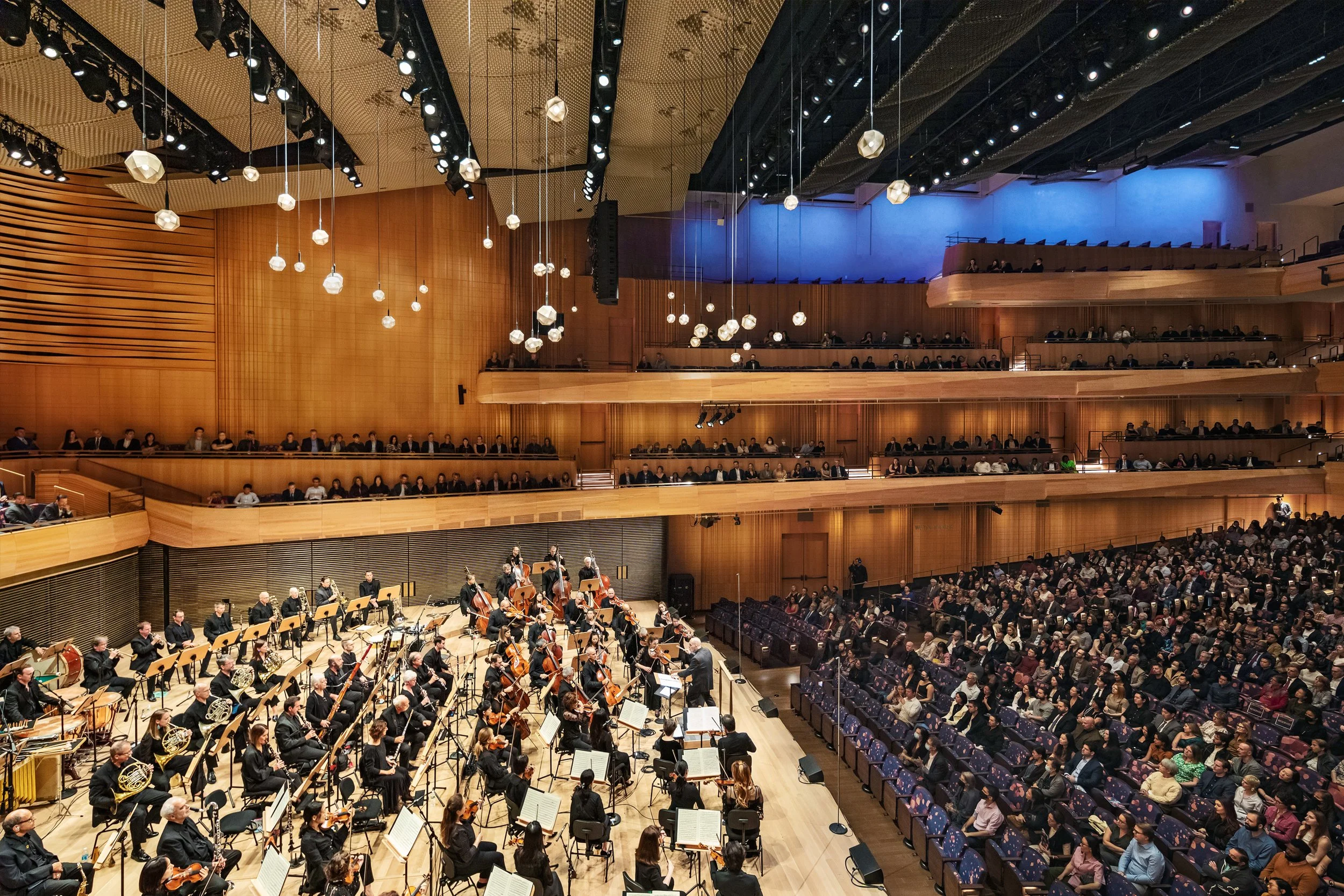 This ceiling at the David Geffen Hall has a custom laser cut sheet metal mesh and mechanically stretched and teased like origami to create this 3D form that rests high above the audience and powder coated in a metallic champagne finish.