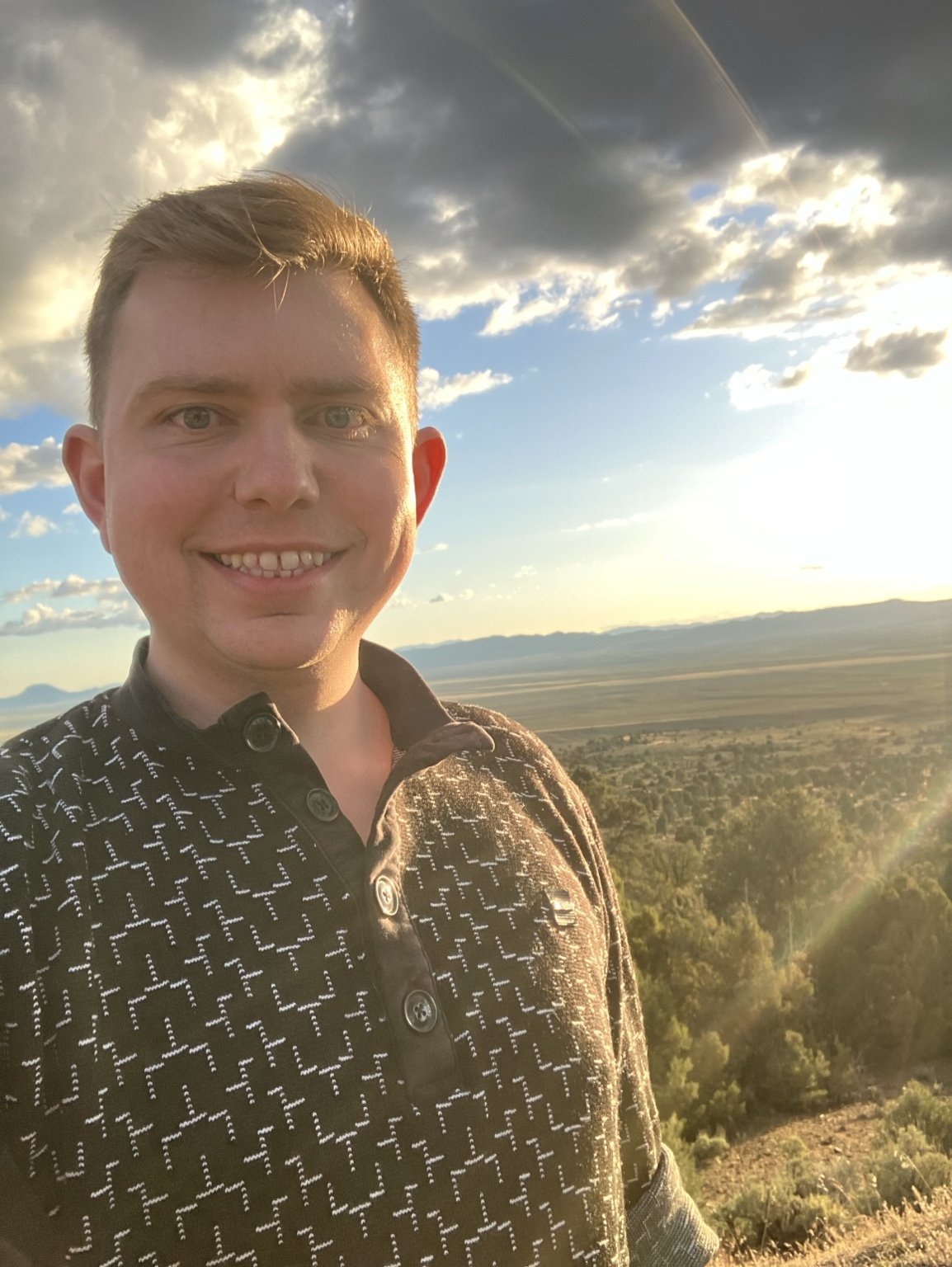 Landon Hester, MD, outdoors in warm sunset light.