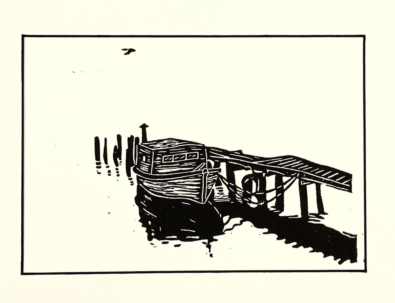 Silhouette of an old fishing boat docked at a pier with bird flying overhead.