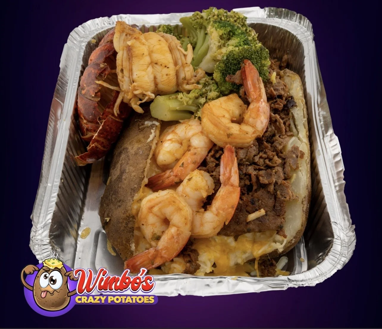 Seafood stuffed baked potato with shrimp, lobster, broccoli, ground beef, and melted cheese in a foil container.