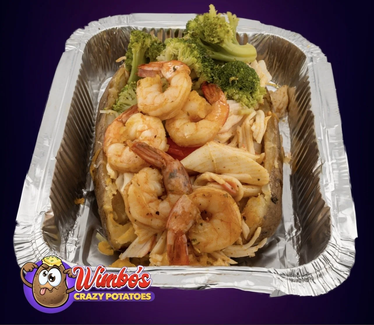 Baked potato topped with shrimp, broccoli, and cheese, served in a foil container with a Wimbo's Crazy Potatoes logo.