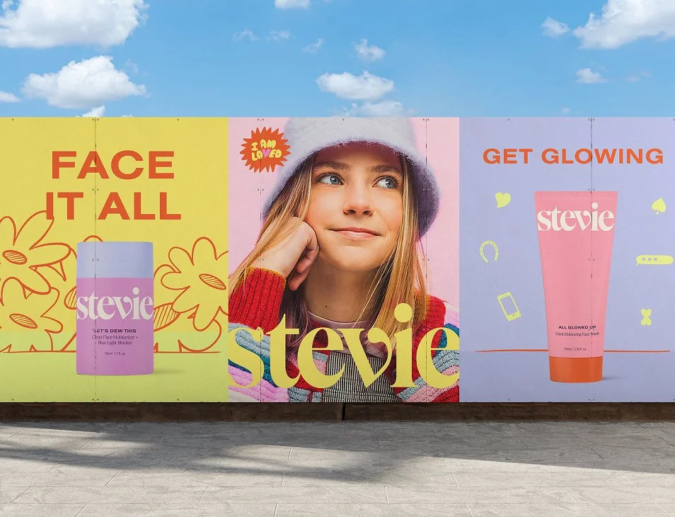 An outdoor poster scene of Stevie skincare branding and packaging with three posters showing a lifestyle image of a teen girl, floral illustrations, and two product packages.