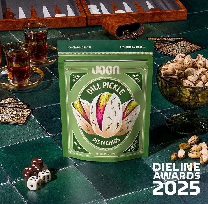 Joon Pistachios Dill Pickle Packaging sitting on a green tile counter.