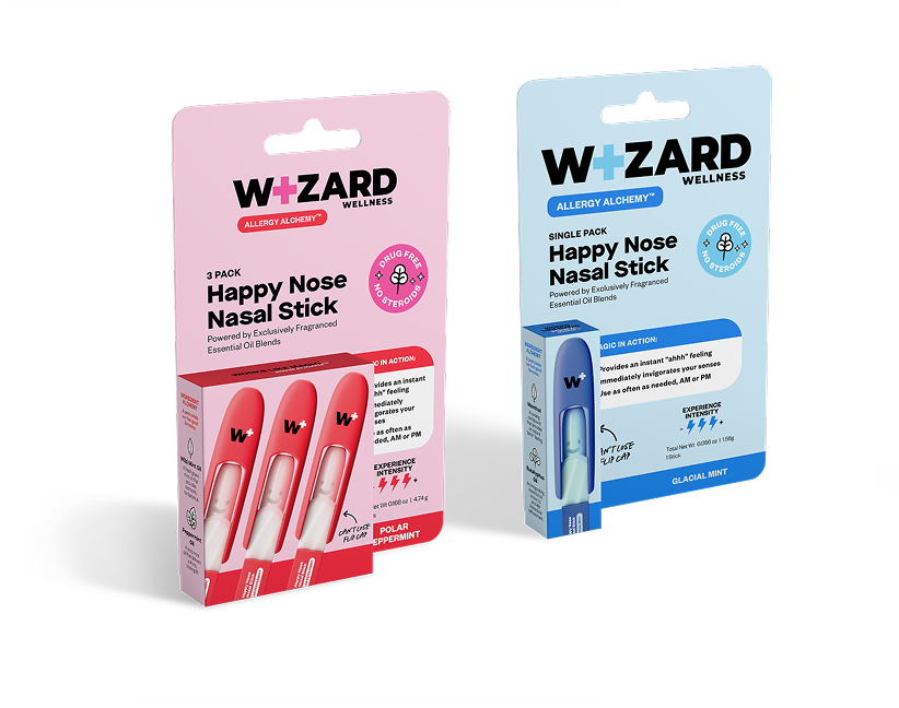 Two different packages of two scents of the Wizard Wellness Happy Nose nasal stick product.