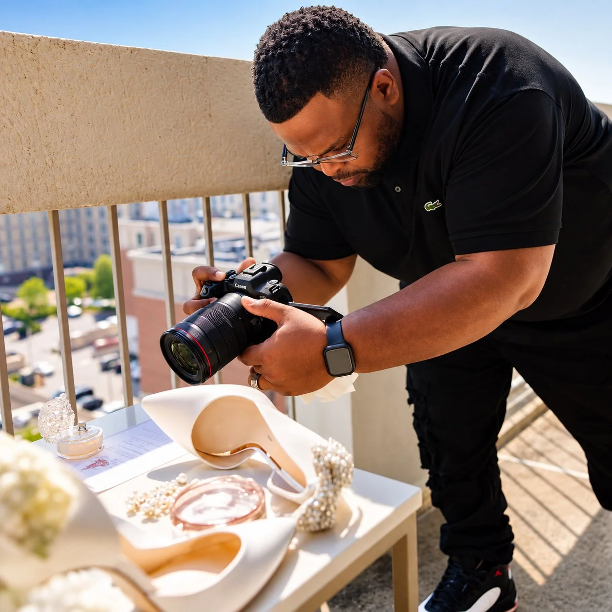 Willis Pugh photographing wedding accessories with a Canon camera behind the scenes at Pugh Logic Productions.