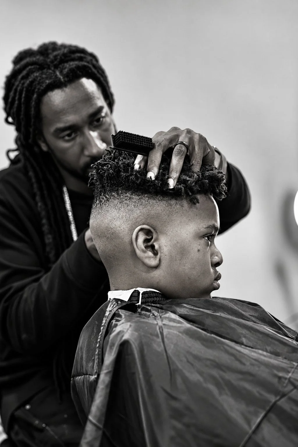Black-and-white barbershop documentary photograph by Pugh Logic Productions.