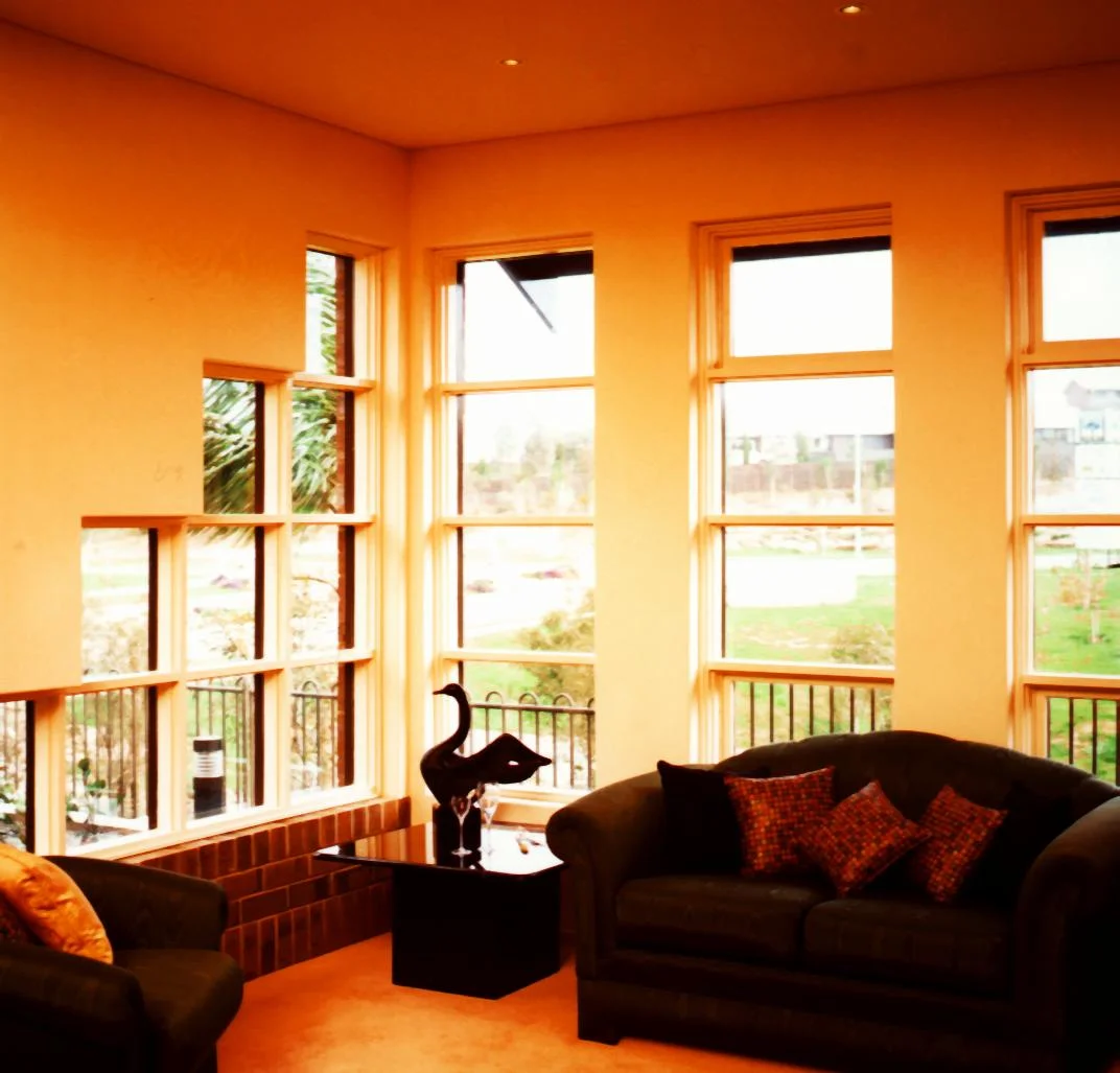 Living room with tall timber-framed windows